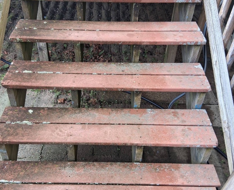 Weathered wood deck stairs before cleaning