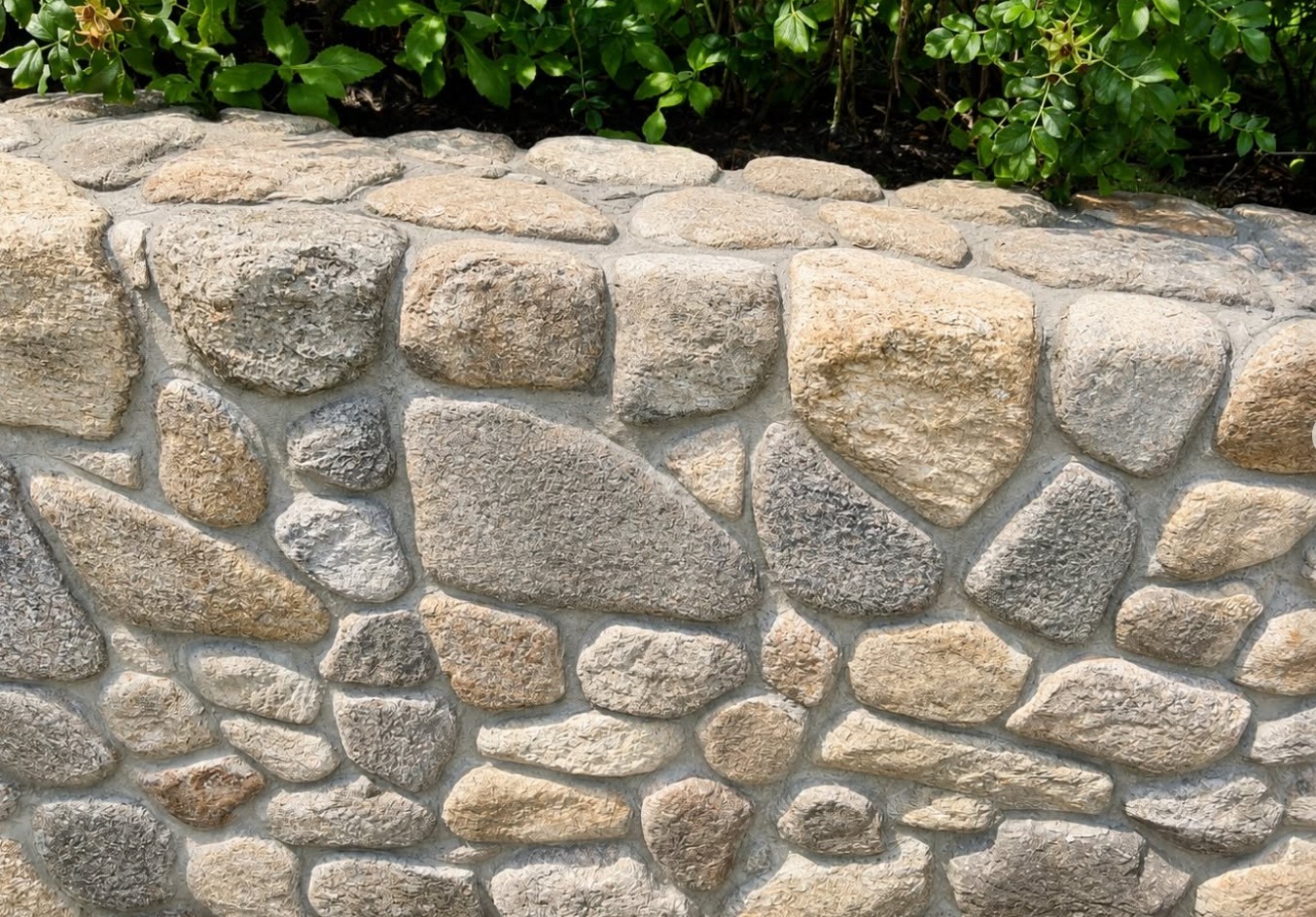 Stone retaining wall cleaned by JJC Pressure and Softwash